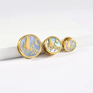 Detailansicht von drei verschiedenen Größen goldener Edelstahl-Ohrplugs mit Eulenmotiv