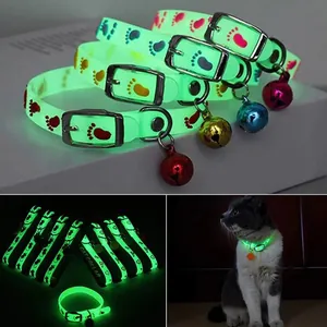 Close-up view of phosphorescent silicone cat collars showing green glow in the dark