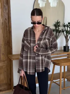 Women's oversized brown plaid long sleeve shirt with double pockets in street style.