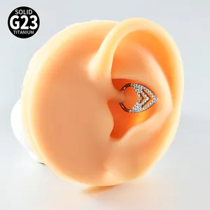 Macro view of a V-shaped G23 titanium septum ring with zircons on a silicone ear model