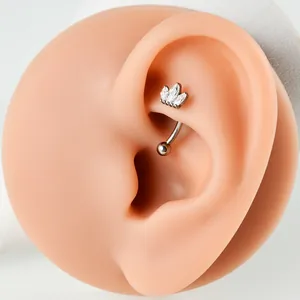 Close-up of G23 titanium rook piercing with marquise-cut zircons on a silicone ear.