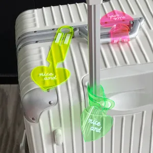 Vibrant fluorescent heart-shaped PVC luggage tags for suitcases in bright neon colors.