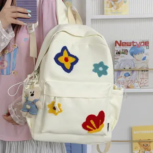 Cute white schoolbag for girls with colorful flower embroidery and plush bear charm