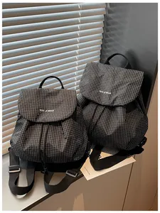 Close-up of lightweight black grid plaid backpacks for casual commuting.
