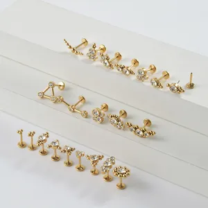 Detail view of multi-style gold stainless steel lip studs with CZ cluster designs