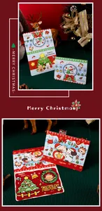 Close-up of creative cartoon Christmas cards with festive bear and Santa designs