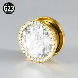 Close-up of gold G23 titanium ear tunnel with sparkling full zirconia inlay