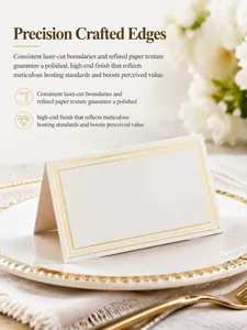 Elegant white wedding place card with gold foil edges displayed on a formal dinner plate