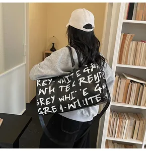 Fashion graffiti travel bag shown on shoulder in a cozy library setting