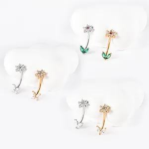 Detail view of various stainless steel floral and butterfly zircon curved barbells