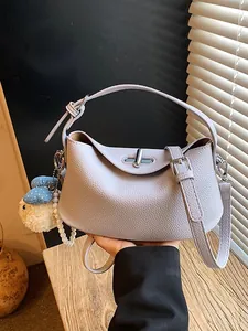Lavender purple textured bucket bag with top handle and crossbody strap