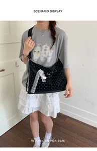Scenario display showing a stylish black polka dot tote bag with lace ribbon accessory