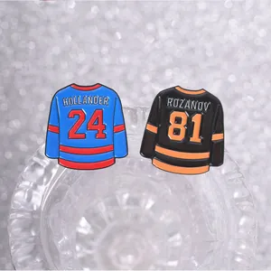 Detailed macro view of hockey jersey enamel pins with Hollander and Rozanov names