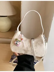 Cream-colored New Chinese style hobo shoulder bag with elegant butterfly pattern and lucky charm