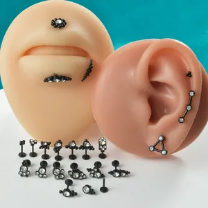 Diverse collection of black stainless steel threadless labret studs and helix earrings
