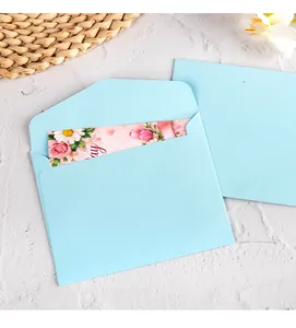 Close-up of light blue offset paper envelope with floral greeting card detail