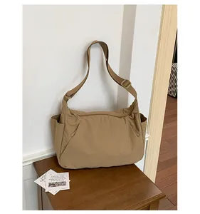 Close-up view of the minimalist khaki lightweight nylon crossbody tote bag for travel