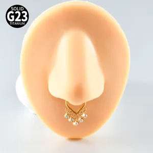 Detailed view of G23 titanium V-shaped septum ring with sparkling zircon tassels.