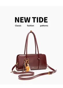 Detailed view of maroon retro crossbody handbag with decorative charms