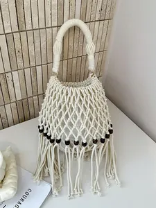 Handmade off-white macrame bucket bag with fringe tassels and wooden beads for summer.