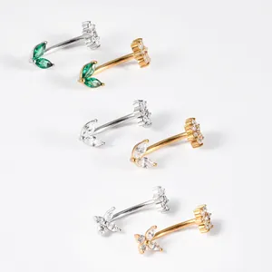 Close-up of assorted stainless steel curved barbells with leaf and flower zircon detail