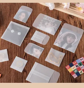 Detailed view of translucent vellum paper envelopes in various sizes on wood background