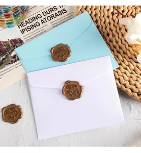 Close-up of small colored paper envelopes with decorative bronze Thank You wax seals.
