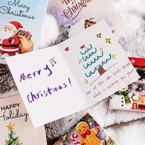 Creative hand-drawn Christmas greeting cards with festive illustrations displayed on snow