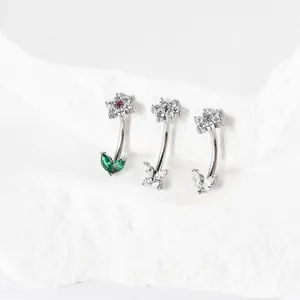 Close-up of 16G stainless steel curved barbells with butterfly and flower zirconia