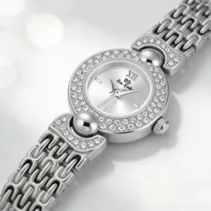 Close-up detail of silver vintage luxury watch with crystal bezel and link bracelet