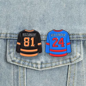 Close-up of Rozanov 81 and Hollander 24 hockey jersey enamel pins on a denim jacket.