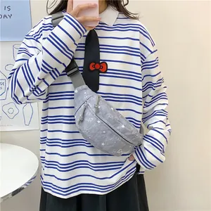 Detail view of gray star pattern waist bag worn as a crossbody chest pack style