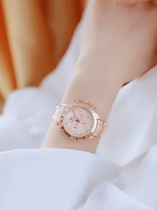 Elegante reloj de mujer en oro rosa con esfera de tres ojos y correa de acero en la muñeca