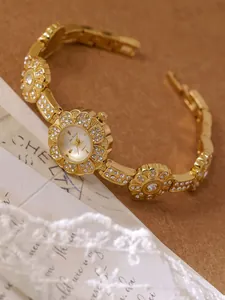 Exquisite close-up detail of a vintage golden floral bracelet watch adorned with crystals
