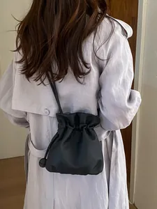 Minimalist black drawstring bucket bag for women stylish shoulder and crossbody style