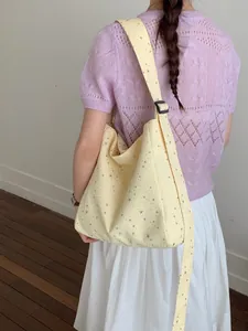 Large capacity pale yellow canvas shoulder bag featuring silver sequin star patterns