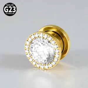 Macro detail of a G23 titanium gold ear plug with sparkling cubic zirconia inlay.