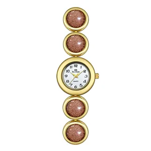 Elegante reloj de mujer dorado con pulsera de eslabones de piedra de arena estelar marrón