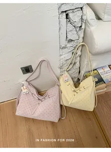 Lifestyle view of stylish pink and cream yellow polka dot tote bags with rabbit charms