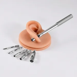 Professional 316L stainless steel dermal punch tool set shown with a silicone ear model