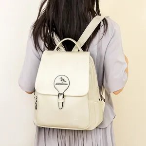 Vue arrière d'un sac à dos élégant en cuir blanc cassé porté par un mannequin chic
