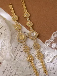Detailed view of vintage style gold floral bracelet watches with sparkling crystal accents