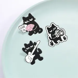 Set of 3 cartoon black cat enamel pins featuring camera, guitar, and brain motifs.