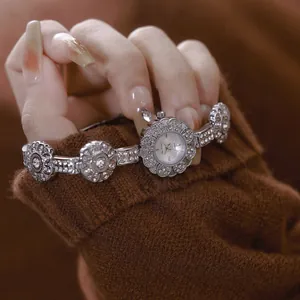 Exquisite silver floral bracelet watch featuring intricate rhinestone details and vintage aesthetic