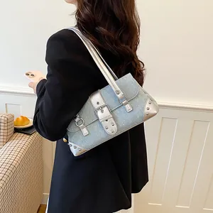Stylish light blue denim baguette shoulder bag with silver metallic buckle and studs