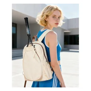 Detailed view of the stylish cream tennis backpack with integrated racket holder.
