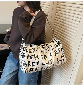 Stylish large capacity travel bag featuring black graffiti letters on white background.