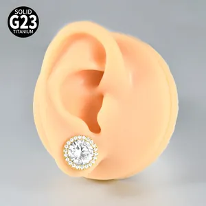 Detail of gold-plated G23 titanium ear expander with halo cubic zirconia stones