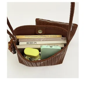 Detail view showing large capacity of brown woven bucket bag with daily essentials