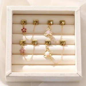 Detailed view of DIY gold Italian modular charms with pink flower and rose designs